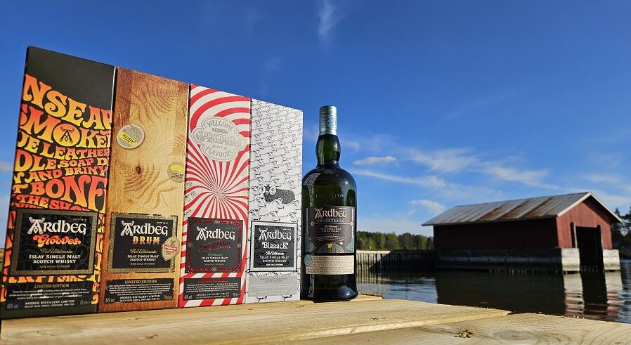 Lineup of various Ardbeg whiskies on a pier